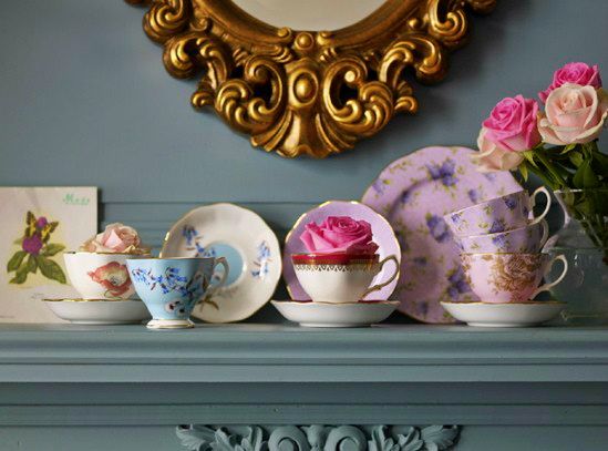 vintage-tea-cups14 Vintage tea cups with roses on a blue mantel beneath a gold mirror
