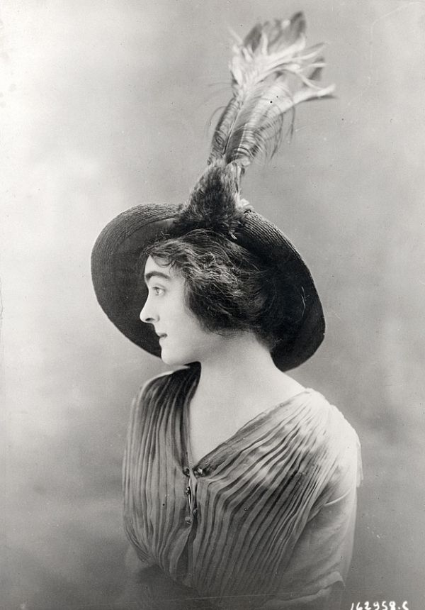Early 1910s fashion portrait focusing on hat and coiffure