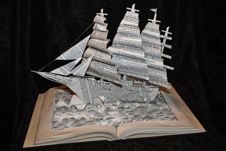 Three-masted paper ship sailing from an open book