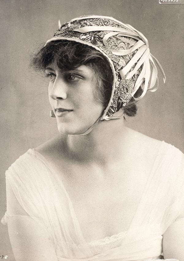 Woman wearing a decorated millinery piece typical of 1913–1915