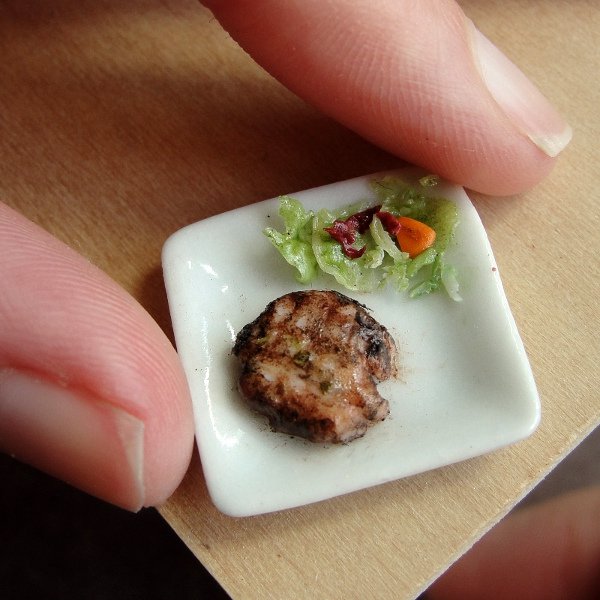 delicious-mini-foods11 Tiny square plate with grilled meat and side salad held between fingers